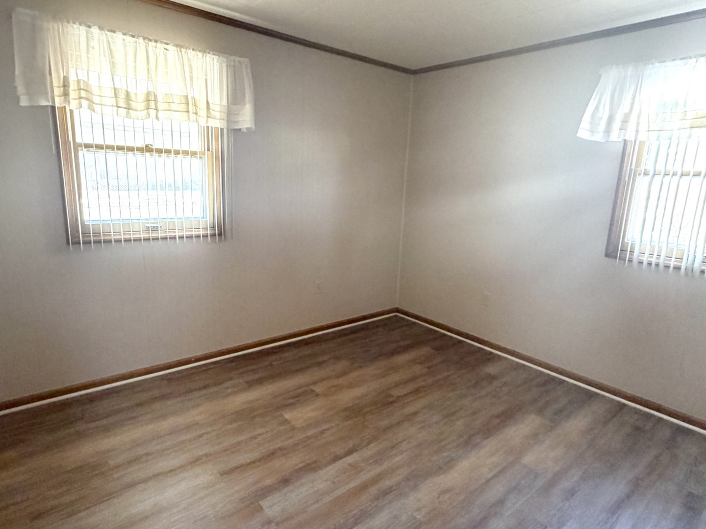 2007 Schuyler Drive Peru, IL 61354 - Photo 5 of 13 an empty room with wooden floor and windows