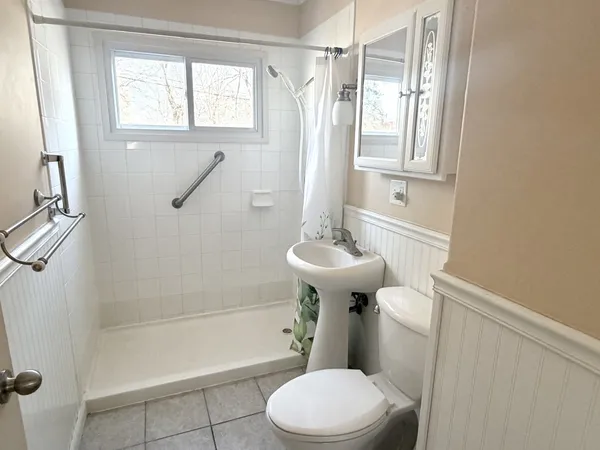 a bathroom with a sink toilet and shower