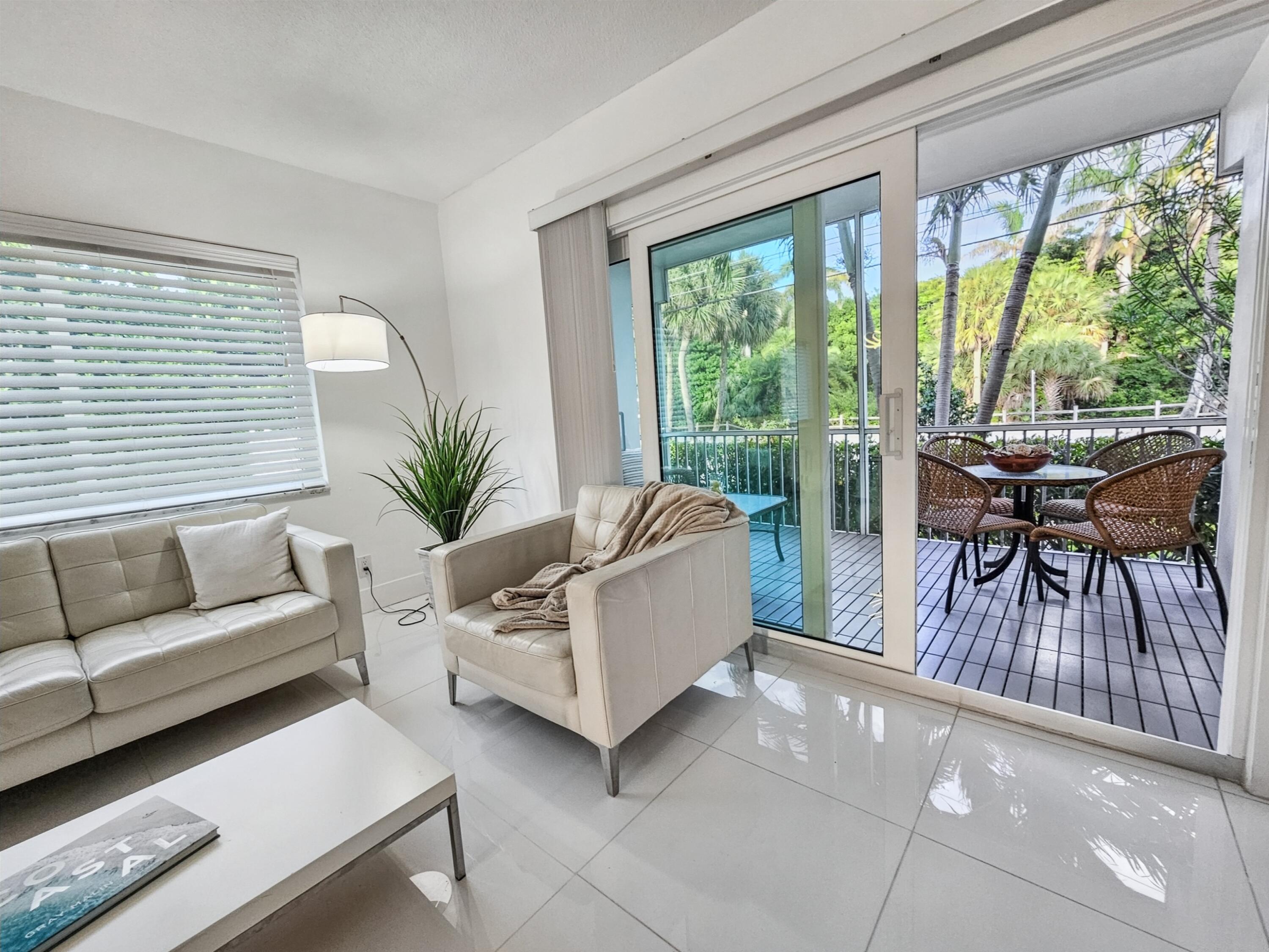 6530 North Ocean Boulevard, Unit 1080 Ocean Ridge, FL 33435 - Photo 19 of 54 a living room with furniture and a large window