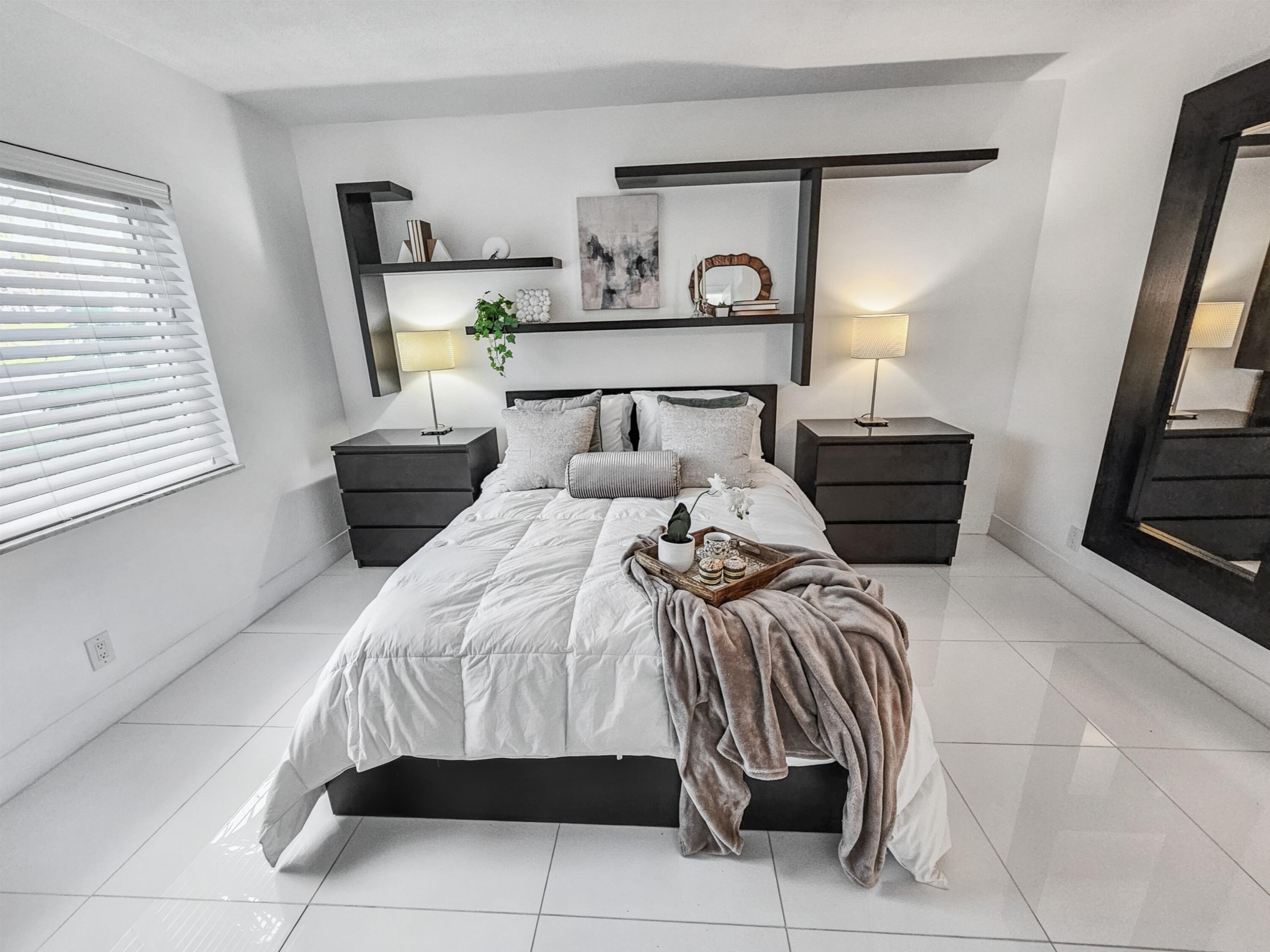 6530 North Ocean Boulevard, Unit 1080 Ocean Ridge, FL 33435 - Photo 22 of 54 a bedroom with a bed and a mirror