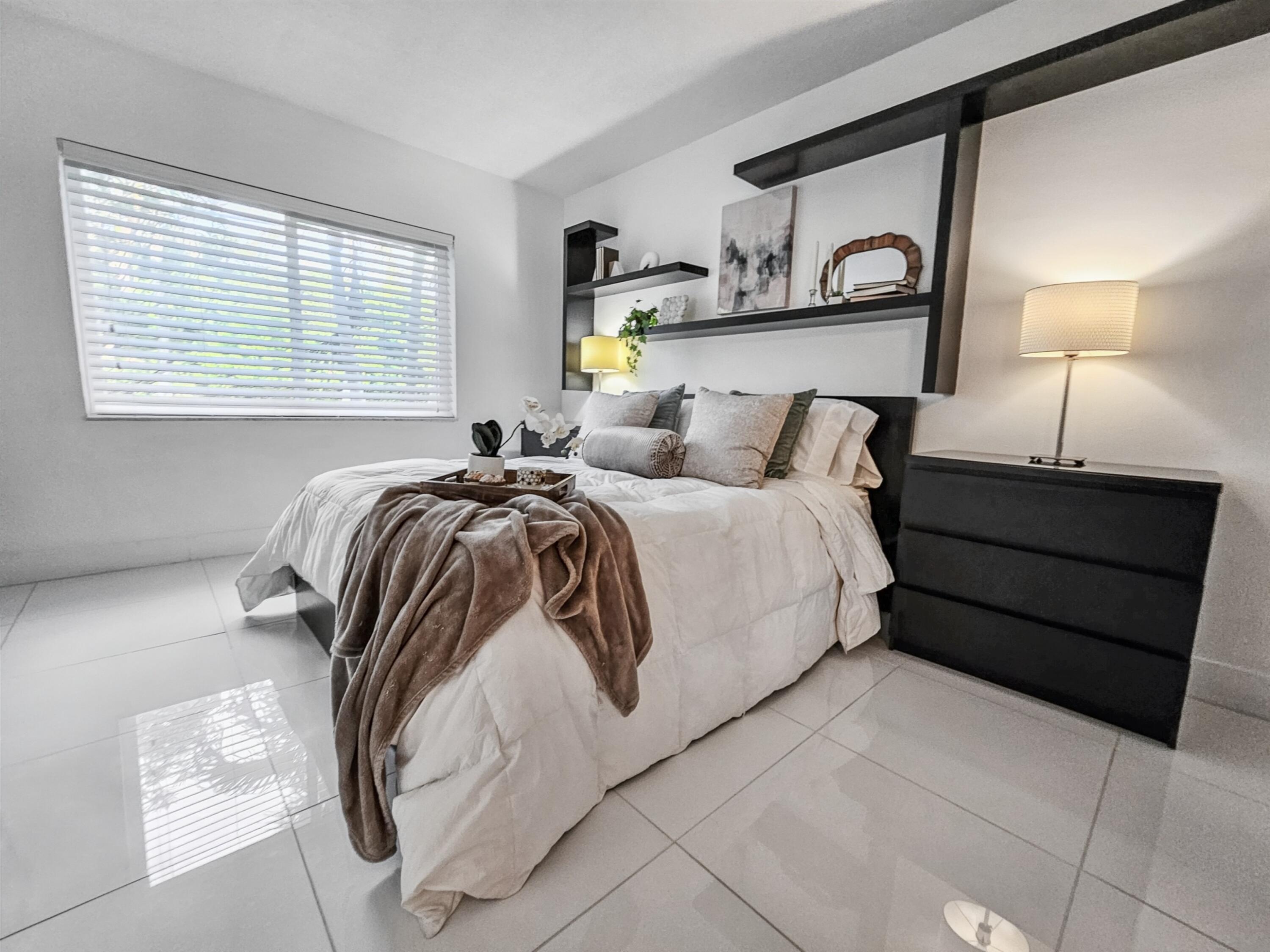 6530 North Ocean Boulevard, Unit 1080 Ocean Ridge, FL 33435 - Photo 23 of 54 a bedroom with a bed and window