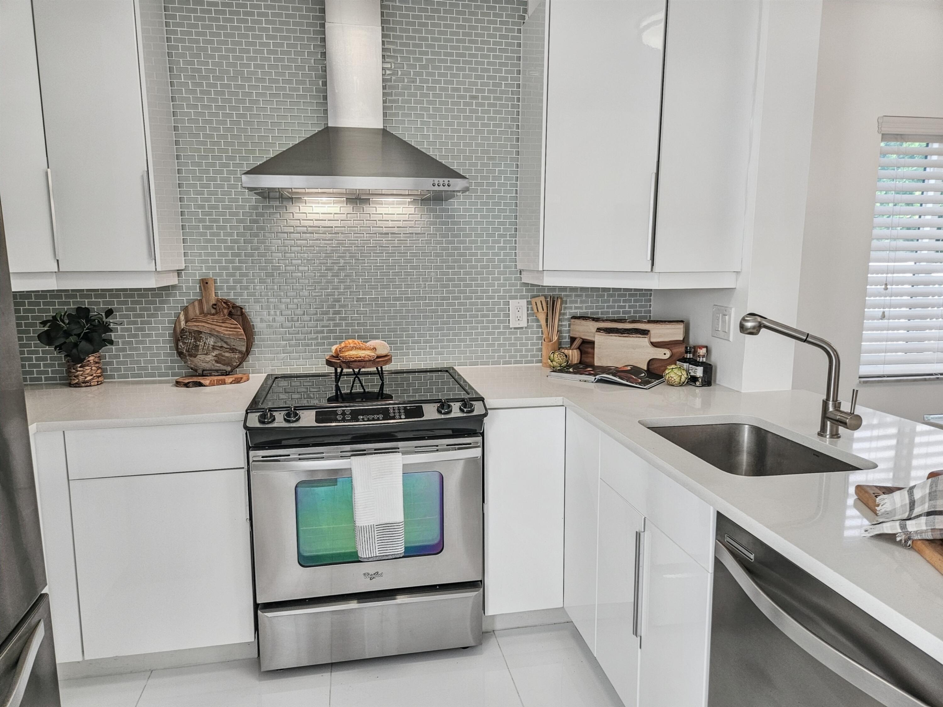6530 North Ocean Boulevard, Unit 1080 Ocean Ridge, FL 33435 - Photo 5 of 54 a kitchen with a stove and a white cabinets