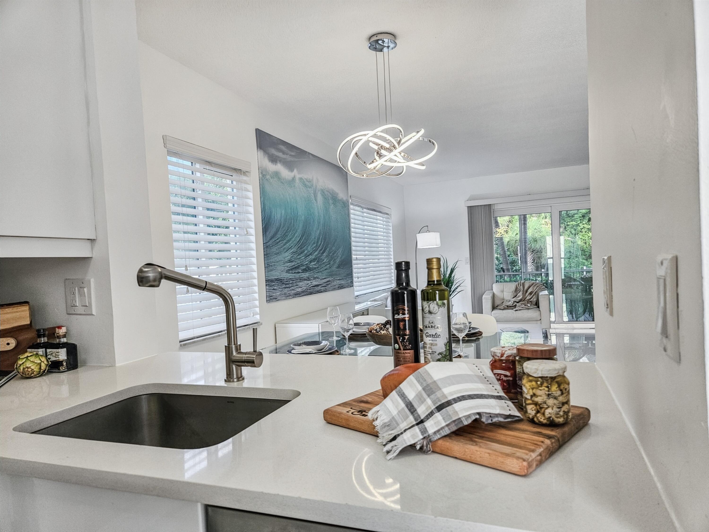 6530 North Ocean Boulevard, Unit 1080 Ocean Ridge, FL 33435 - Photo 6 of 54 a view of a kitchen with kitchen island granite countertop living room
