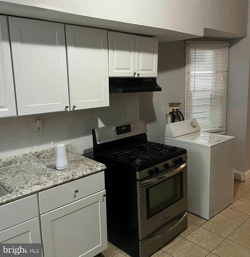 1904 Mosher Street Baltimore, MD 21217 - Photo 7 of 16 a kitchen with granite countertop white cabinets and a stove