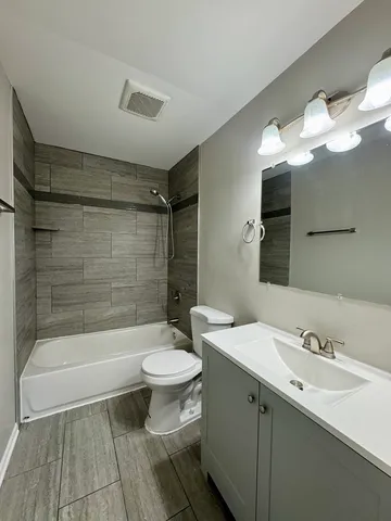 a bathroom with a sink toilet a mirror and shower