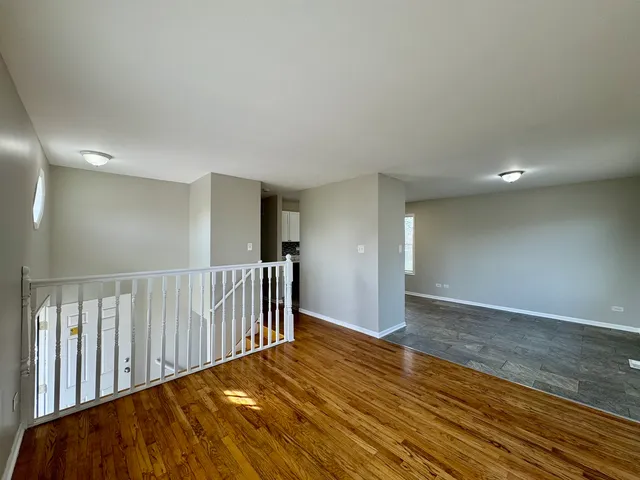 a view of hallway with wooden floor