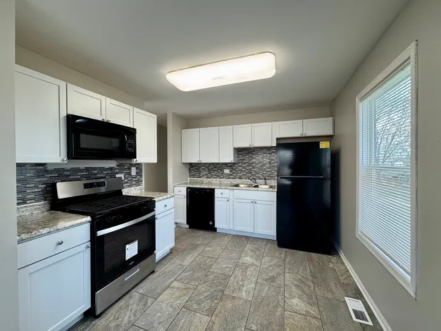 a kitchen with a refrigerator stove and sink