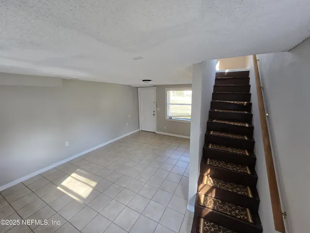 a view of an empty room with windows