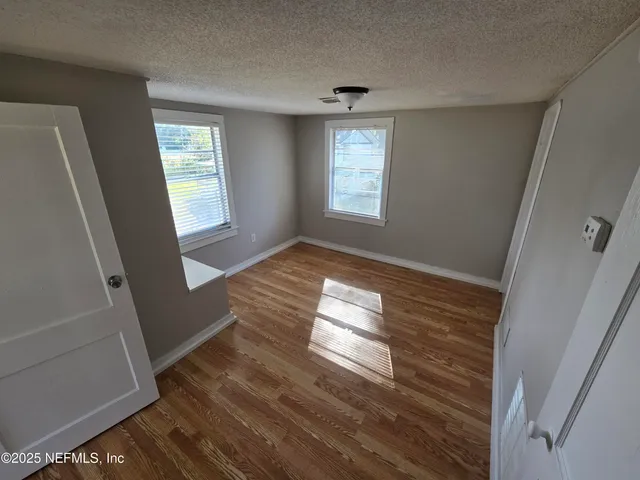 a view of wooden floor and windows in a room