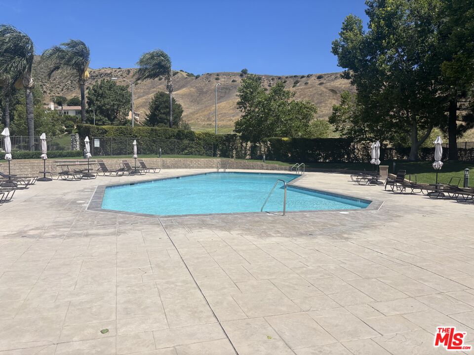 19528 Eagle Ridge Lane Porter Ranch, CA 91326 - Photo 17 of 20 a view of swimming pool with outdoor seating and a garden