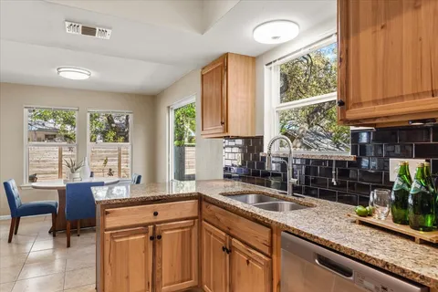 a kitchen with granite countertop a sink and a window