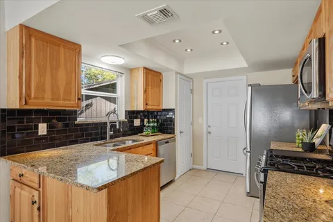 a kitchen with a sink stove and refrigerator