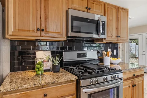 a kitchen with a stove and a microwave
