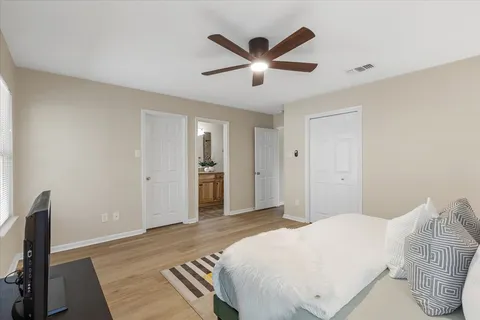 a bedroom with a large bed and a chandelier