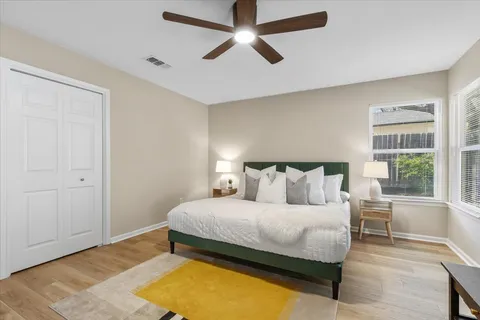 a bedroom with a large bed and a chandelier