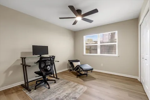 a workspace with wooden floor and a window