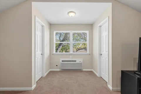 a view of room with window and front door