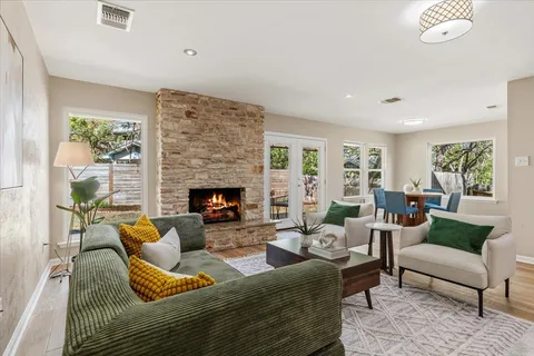a living room with furniture wooden floor and a fireplace