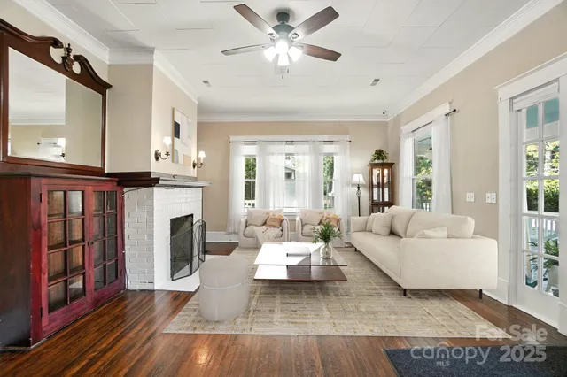 a living room with furniture fireplace and window