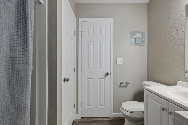 a bathroom with a toilet and a shower