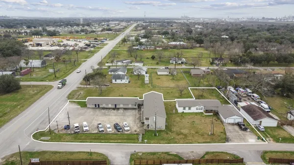 an aerial view of a house with a yard