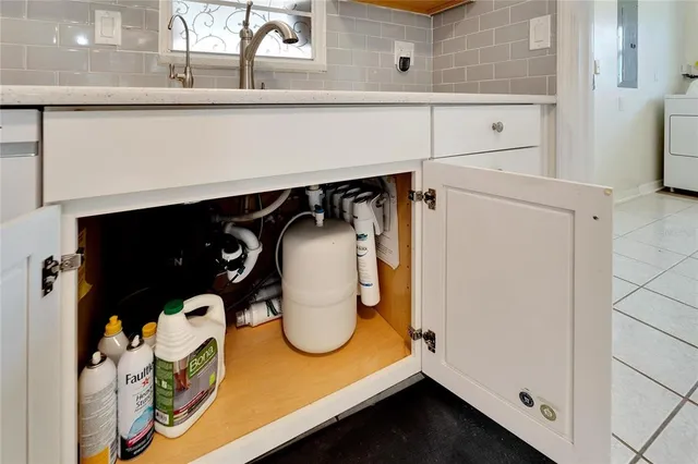 a room with a sink a washer and dryer