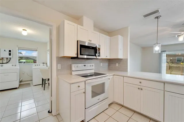 a view of a kitchen with wooden floor and a kitchen