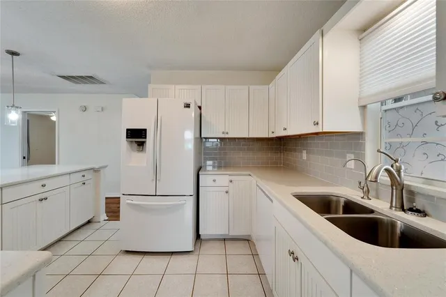 a utility room with cabinets washer and dryer