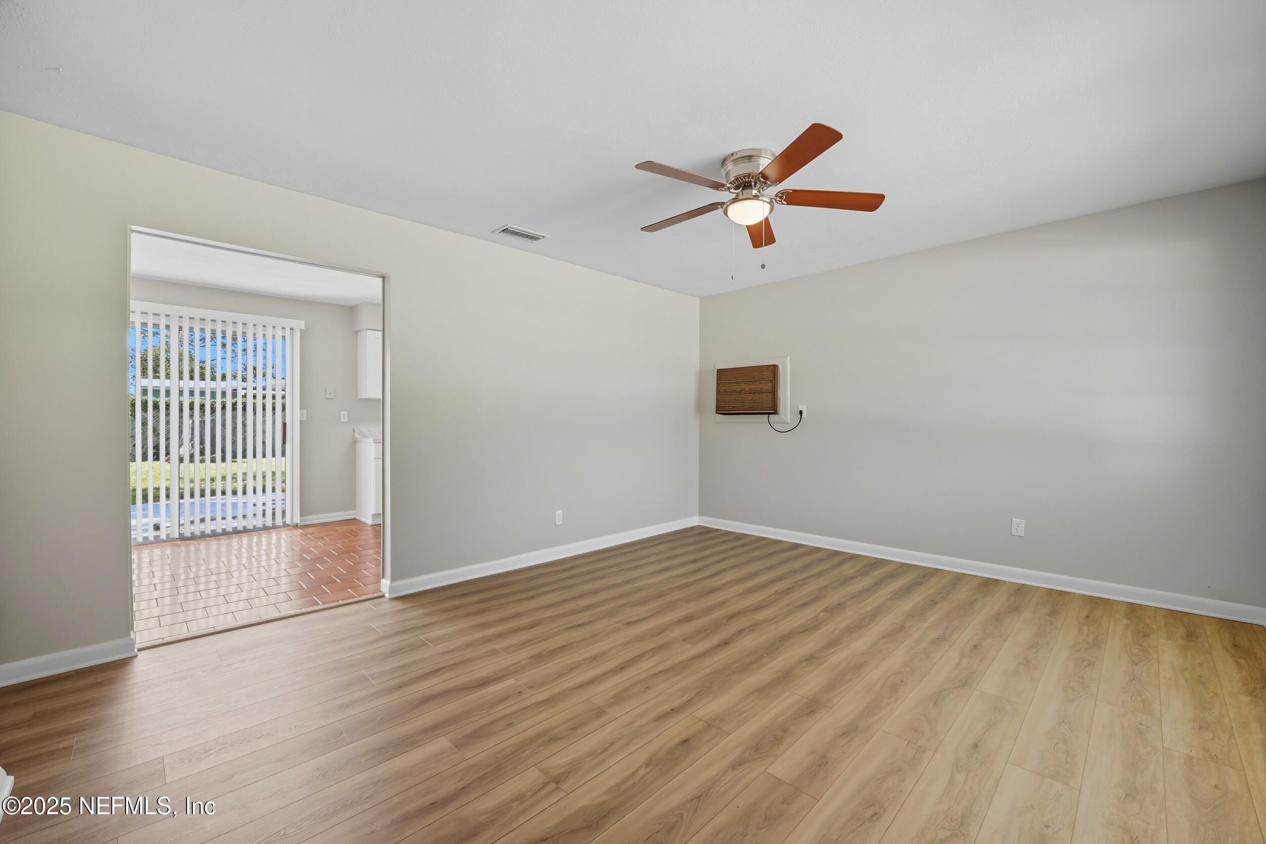 5604 Sabena Road Jacksonville, FL 32207 - Photo 3 of 29 wooden floor in an empty room with a window