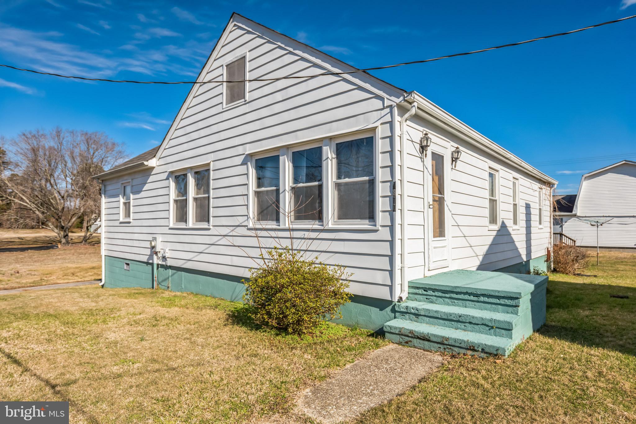 4870 Calvert Drive St. Leonard, MD 20685 - Photo 2 of 13 a front view of a house with a yard