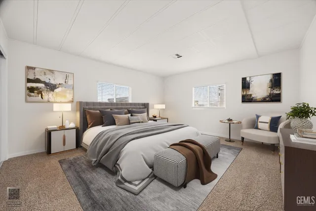 a spacious bedroom with a bed a couch and a flat screen tv