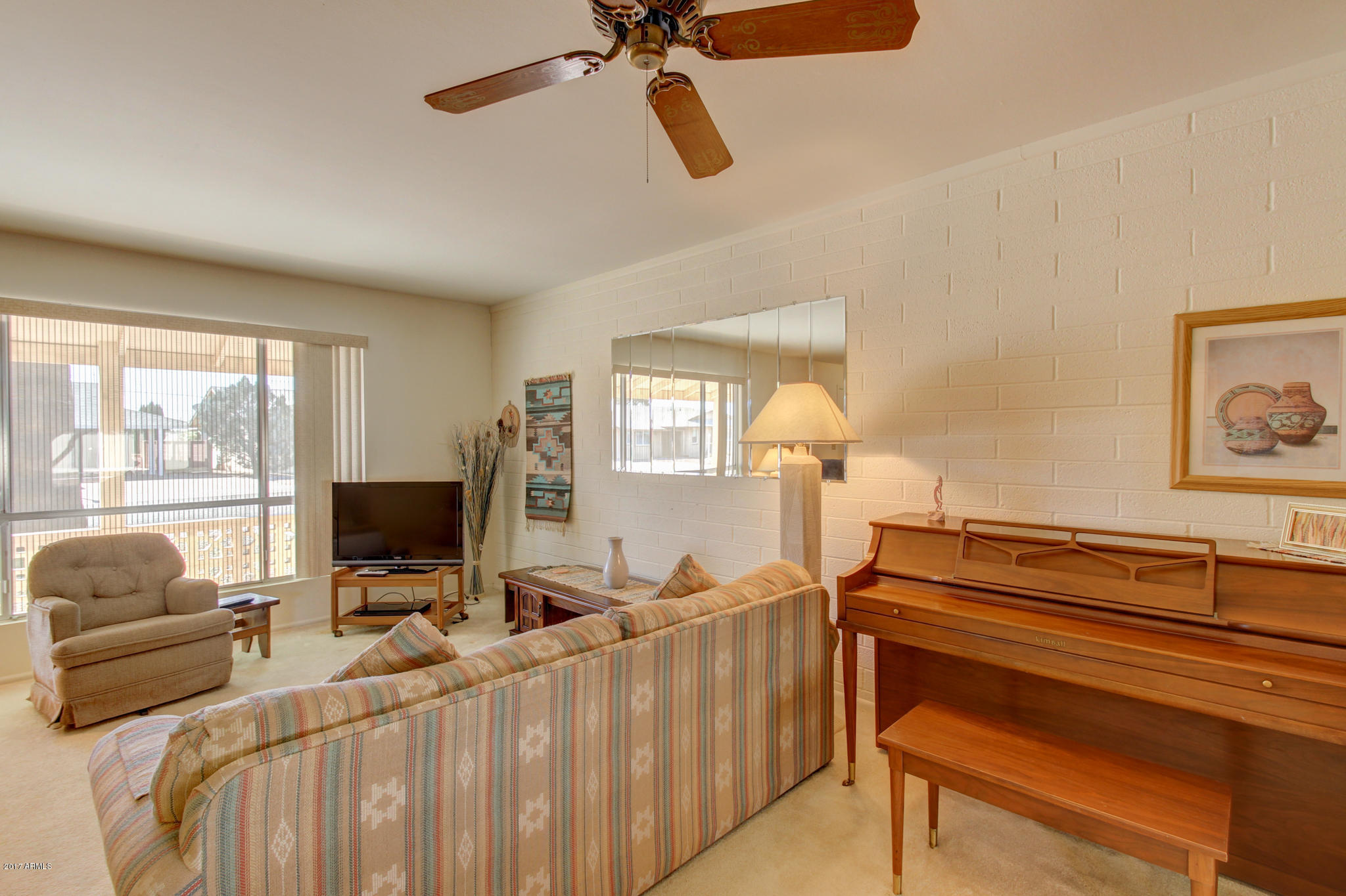 10008 West Riviera Drive Sun City, AZ 85351 - Photo 12 of 26 a bedroom with furniture and a window