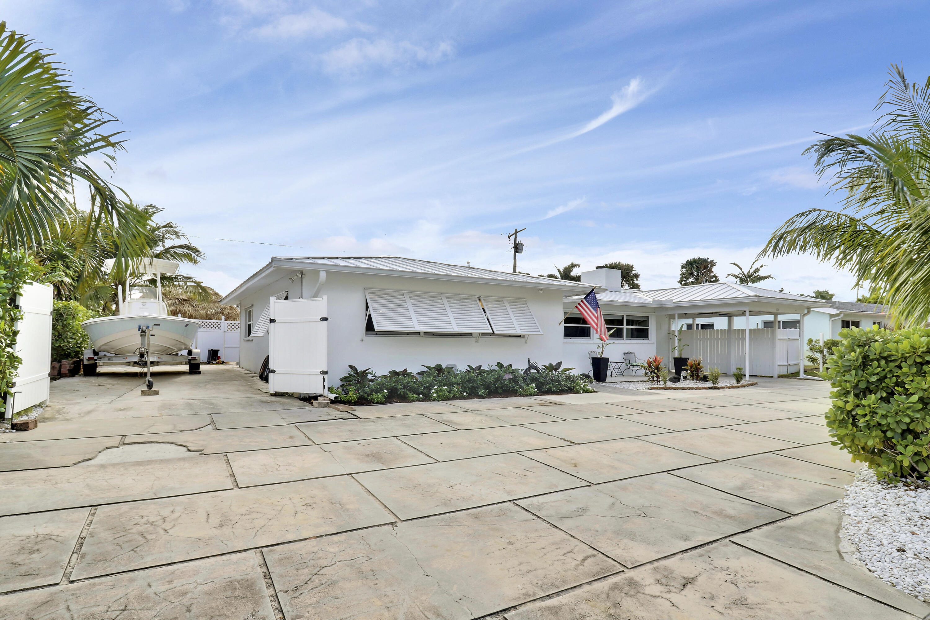 520 Inlet Road North Palm Beach, FL 33408 - Photo 3 of 51 a view of a white house with a outdoor space