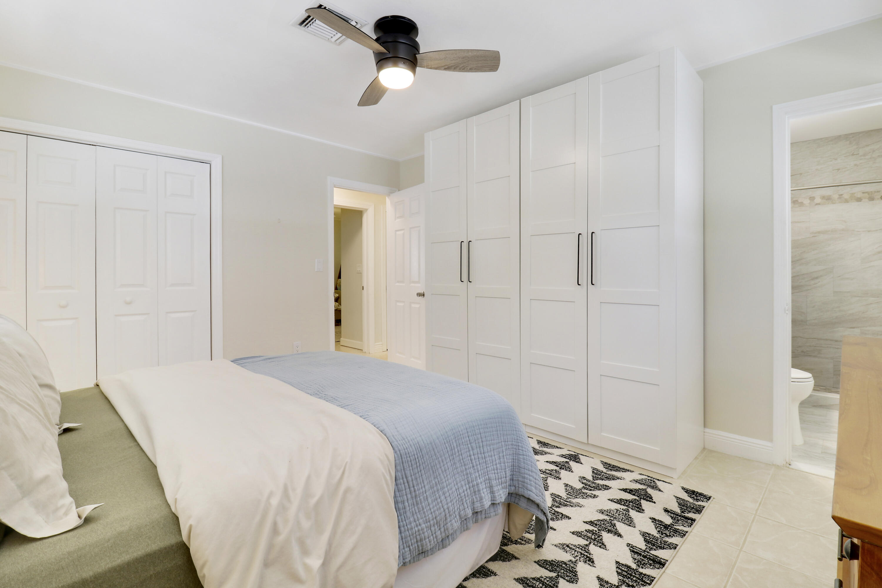 520 Inlet Road North Palm Beach, FL 33408 - Photo 51 of 51 a bedroom with a bed and a chandelier