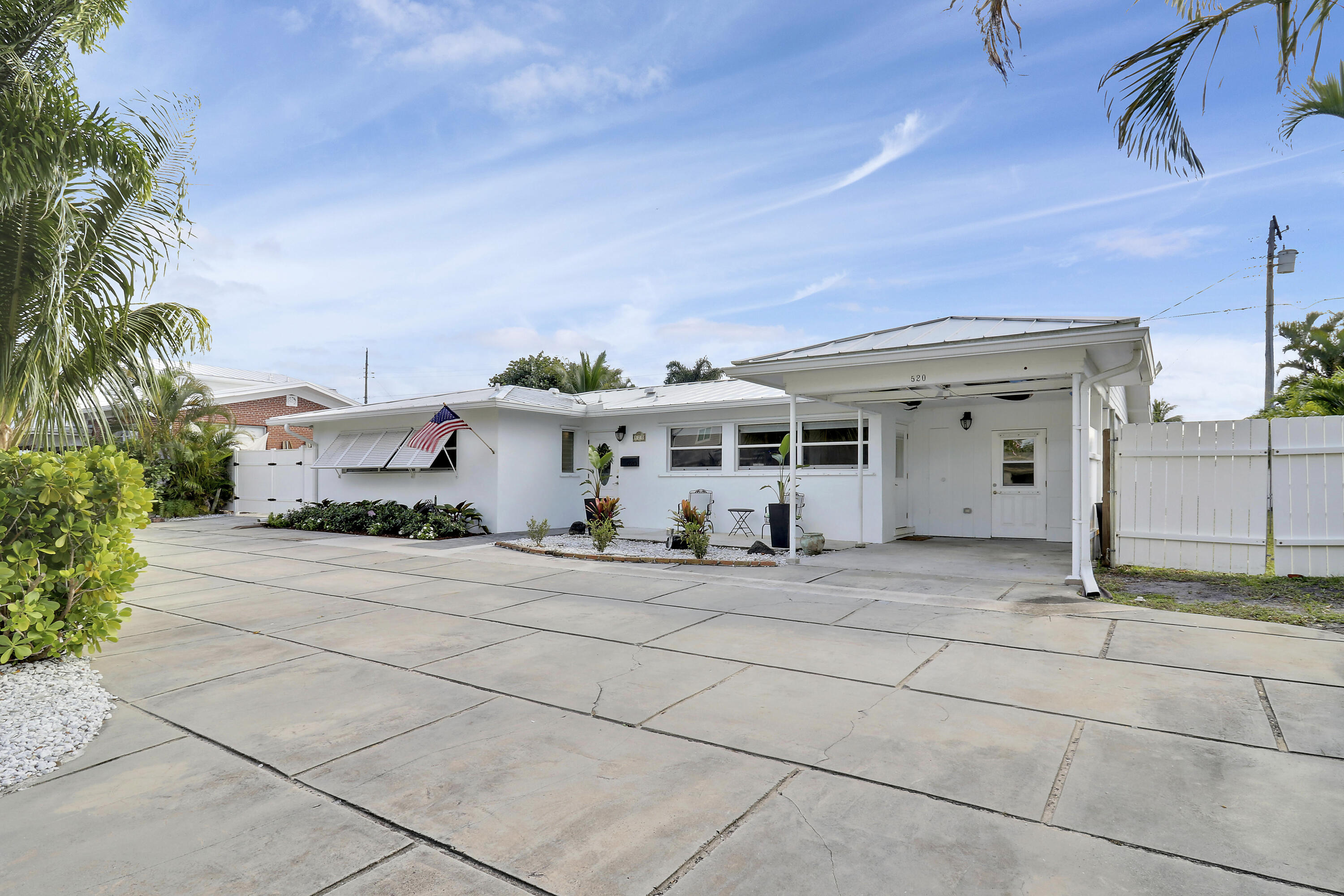520 Inlet Road North Palm Beach, FL 33408 - Photo 10 of 51 a front view of a house with a yard and garage