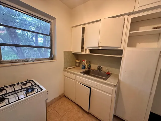a kitchen with stainless steel appliances a sink and a cabinets