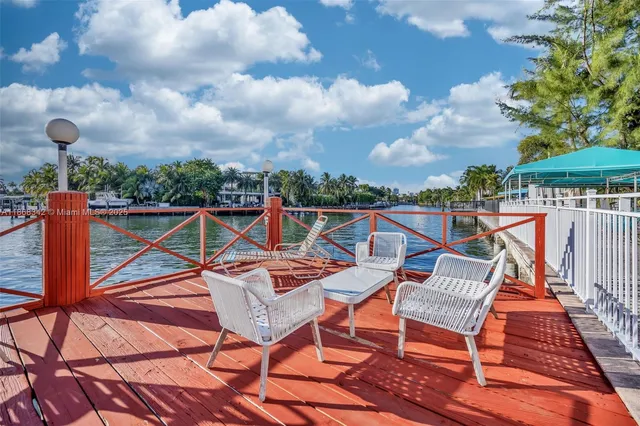 a view of a roof deck with chair and wooden floor