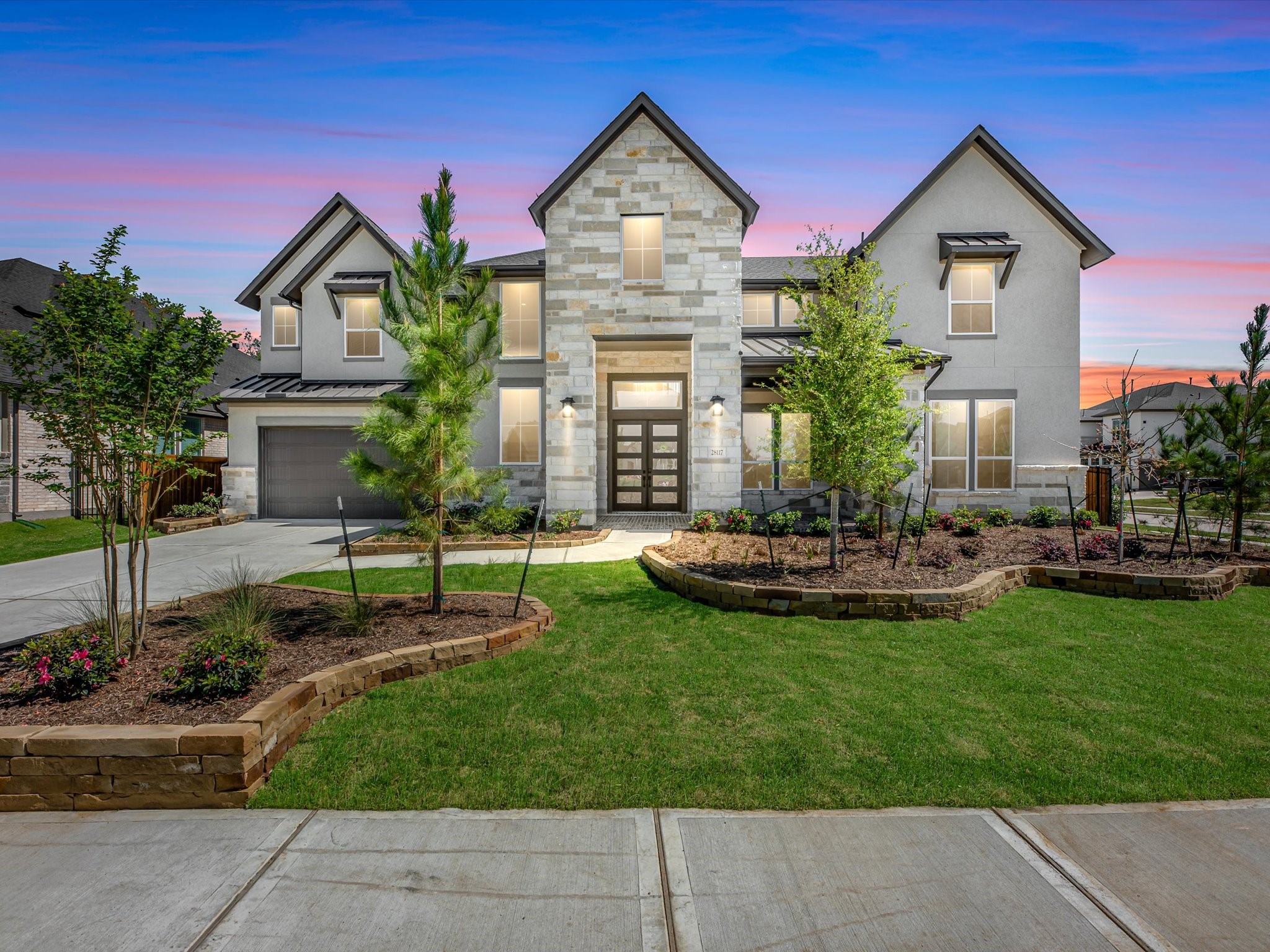 a front view of a house with yard and green space