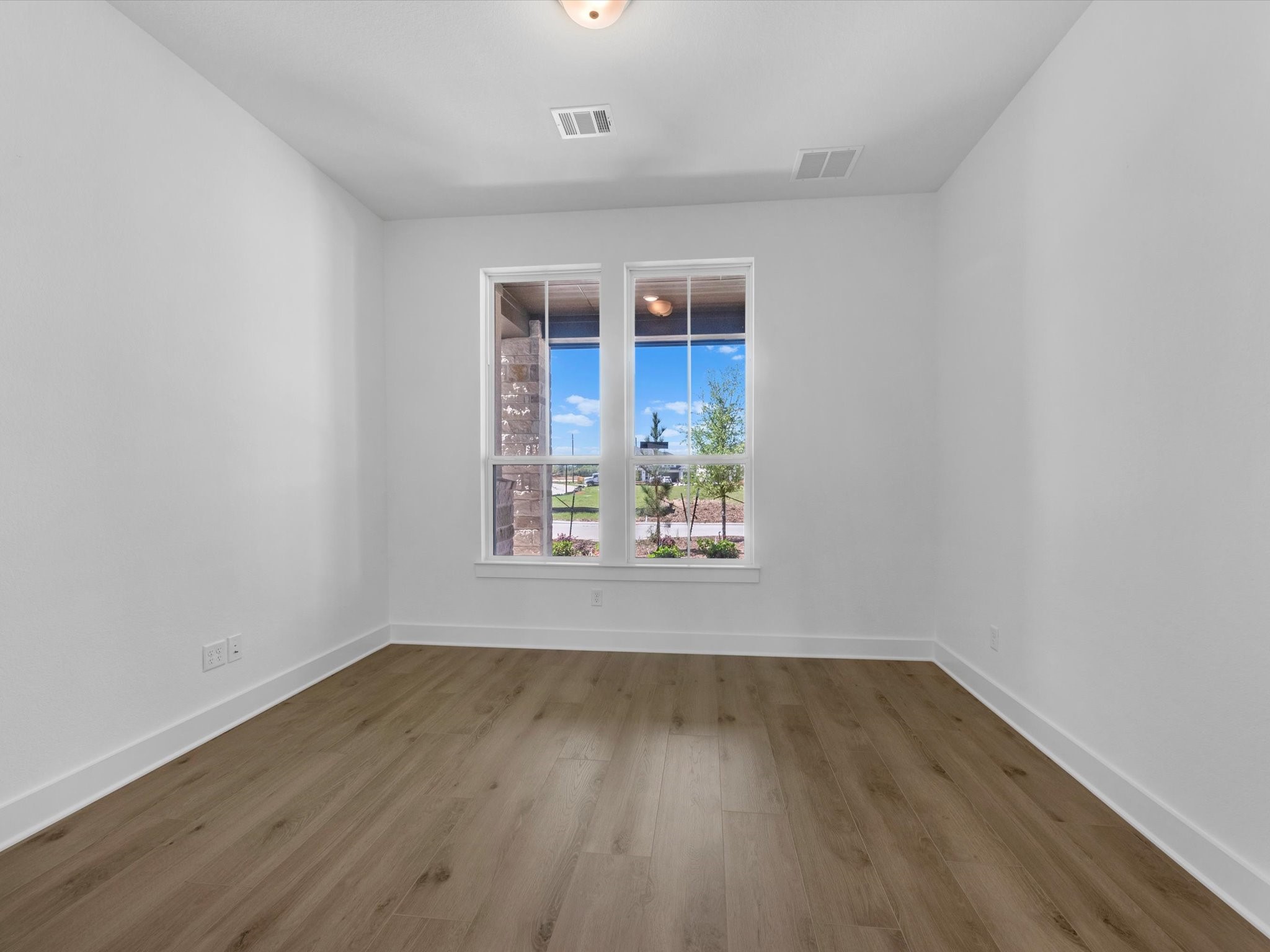 28117 Fox Bnd Drive Spring, TX 77386 - Photo 11 of 26 a view of an empty room with wooden floor and a window