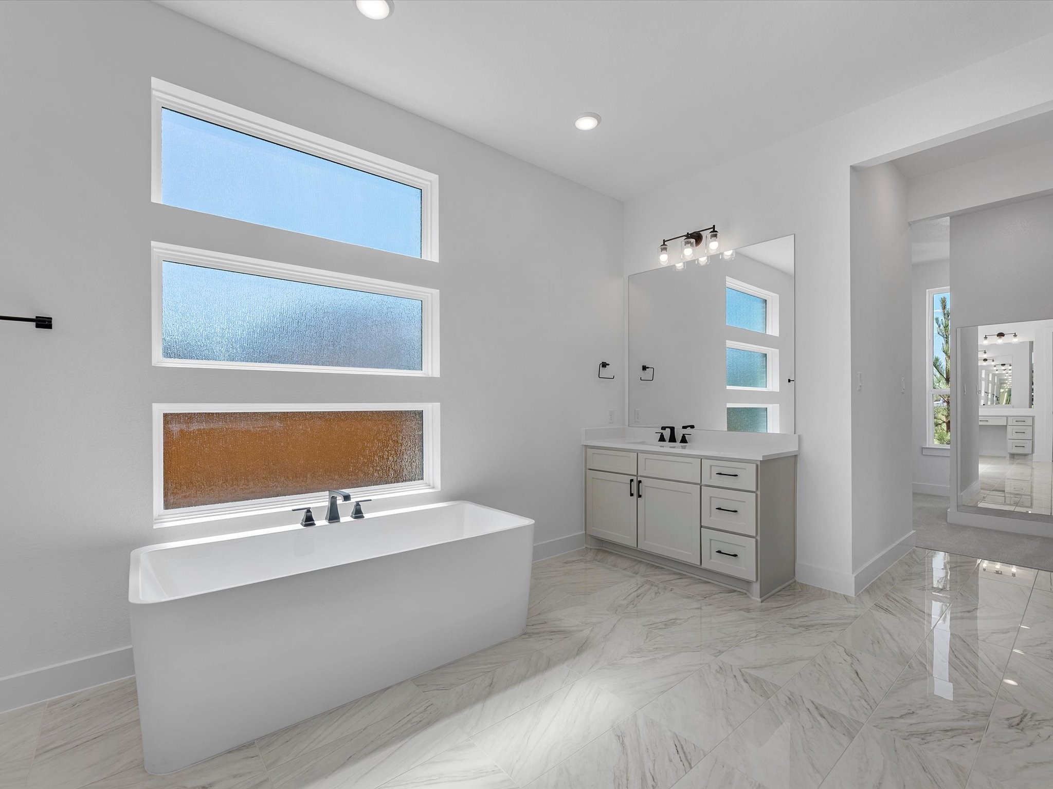 28117 Fox Bnd Drive Spring, TX 77386 - Photo 13 of 26 a bathroom with a tub sink and mirror