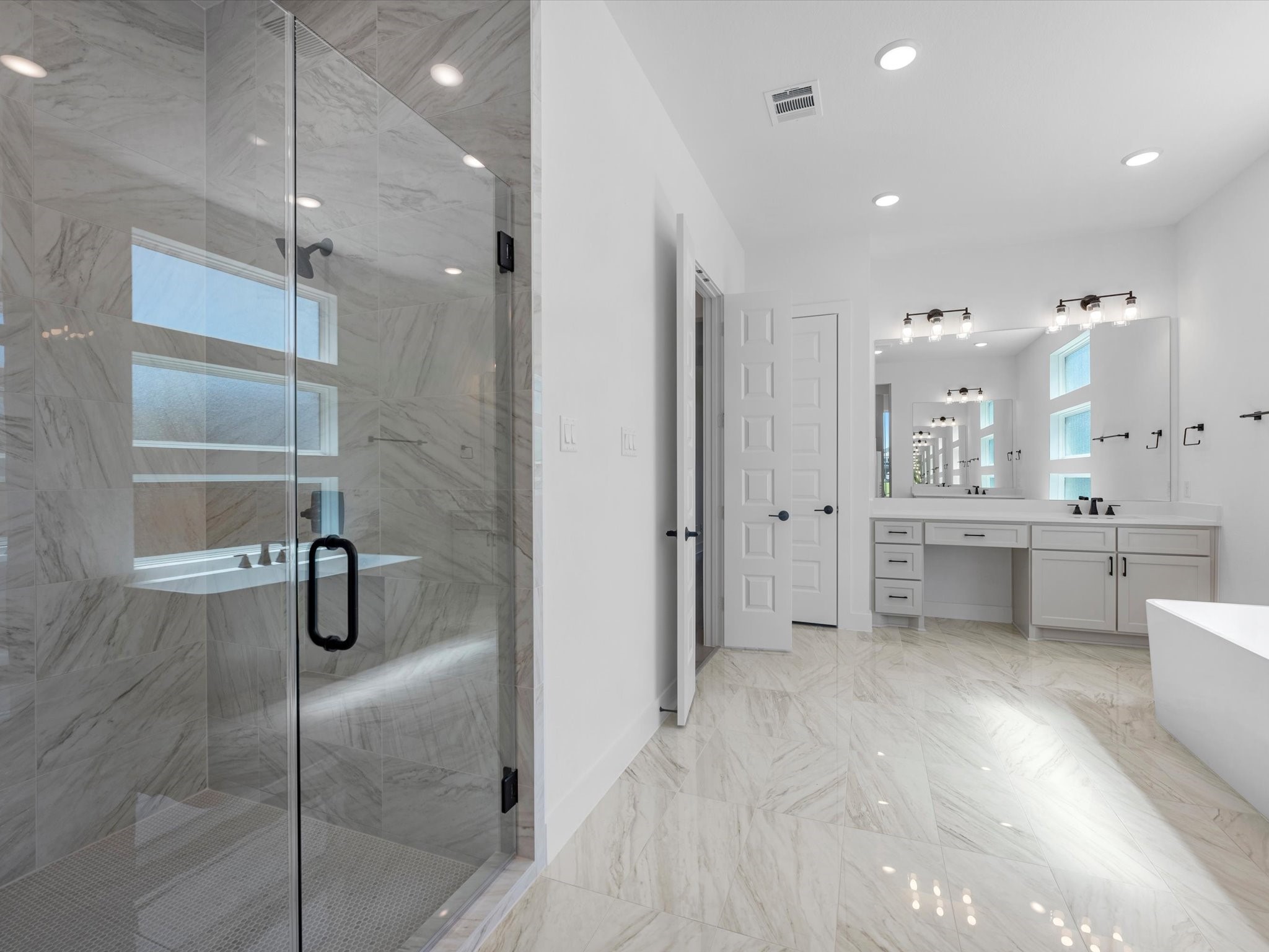 28117 Fox Bnd Drive Spring, TX 77386 - Photo 14 of 26 a bathroom with a double vanity sink a mirror a shower and bathtub