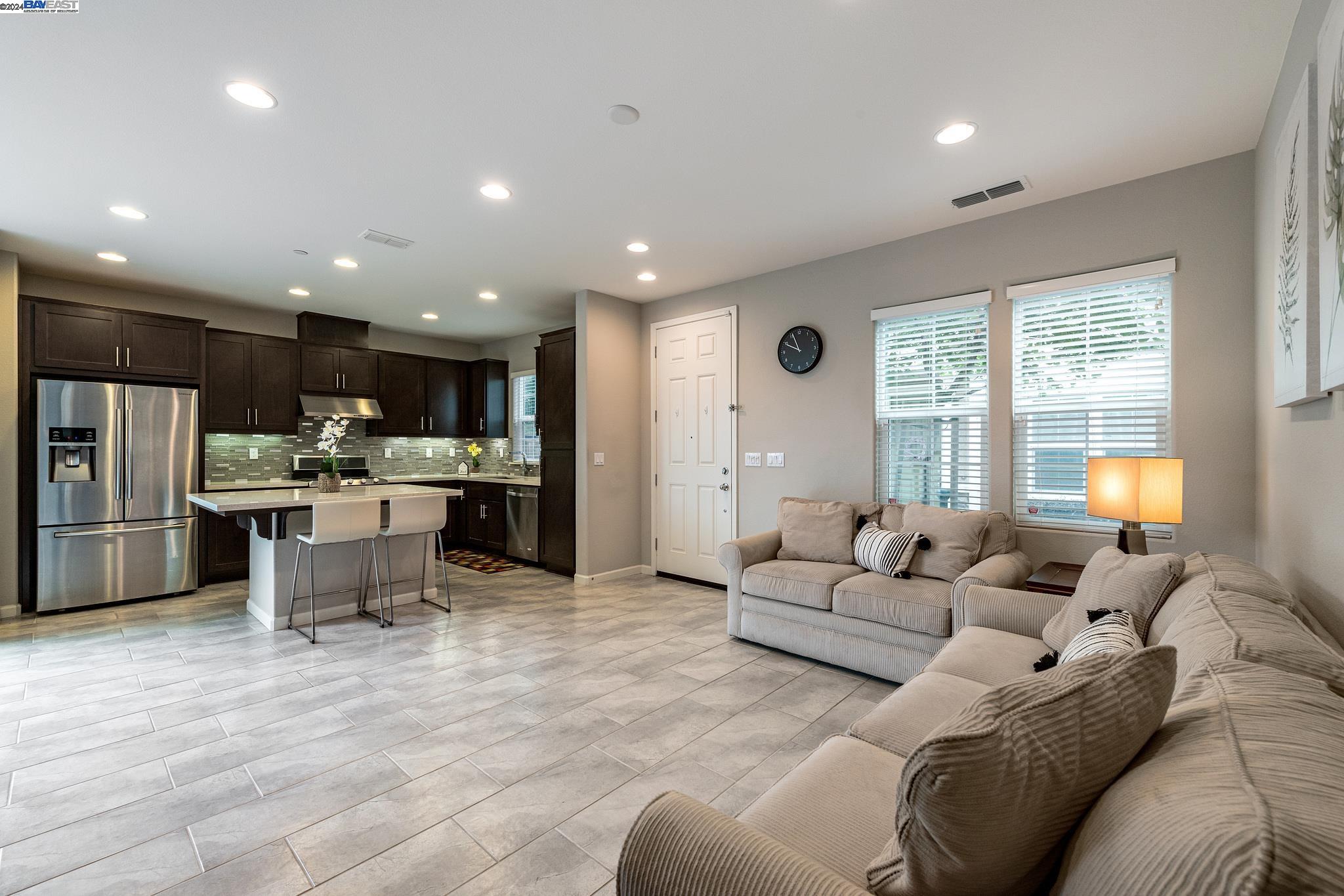 a living room with furniture and kitchen view