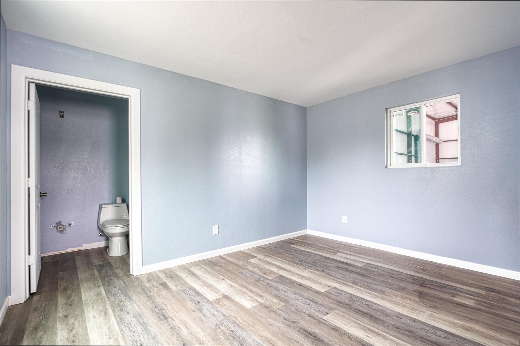 13051 Pleasant Valley Drive, Unit A Rosharon, TX 77583 - Photo 8 of 17 a view of a room with a stylish ceiling fan and hardwood floor