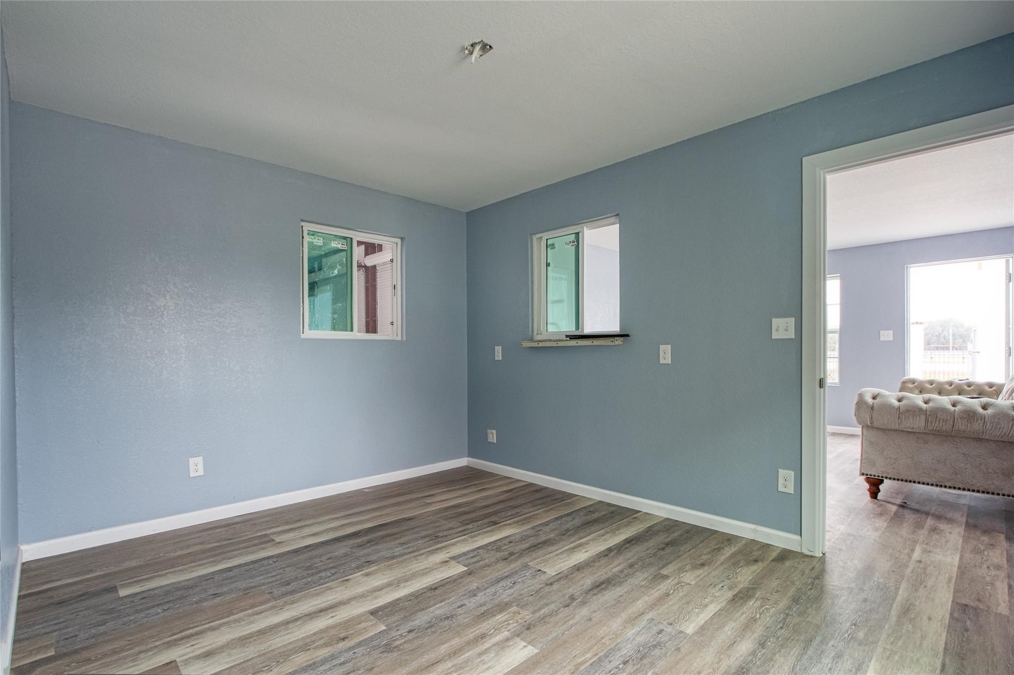 13051 Pleasant Valley Drive, Unit A Rosharon, TX 77583 - Photo 9 of 17 a view of empty room with wooden floor