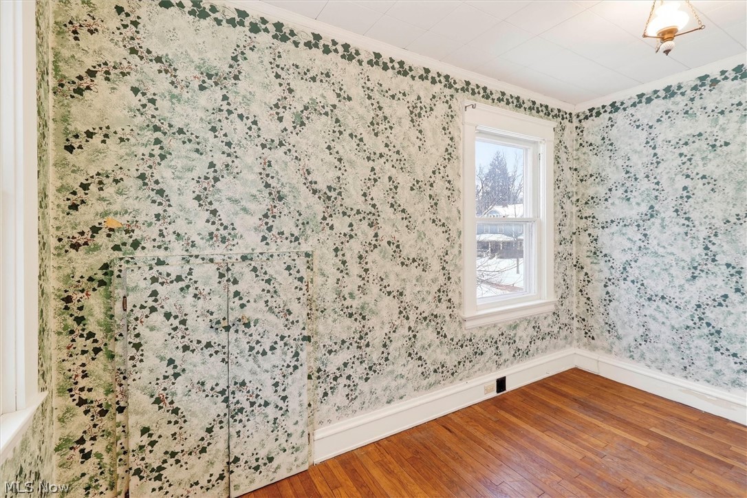 1798 Middlehurst Road Cleveland, OH 44118 - Photo 32 of 49 Unfurnished room featuring hardwood / wood-style flooring and crown molding