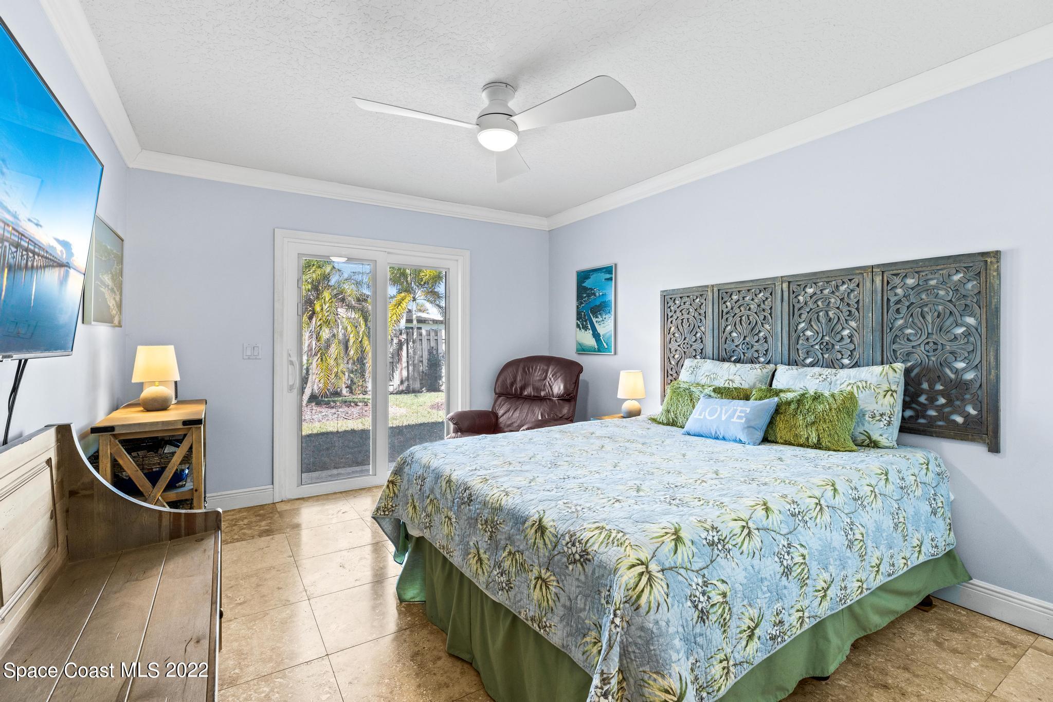 470 Veracruz Boulevard Indialantic, FL 32903 - Photo 11 of 25 a bedroom with a bed and wooden floor