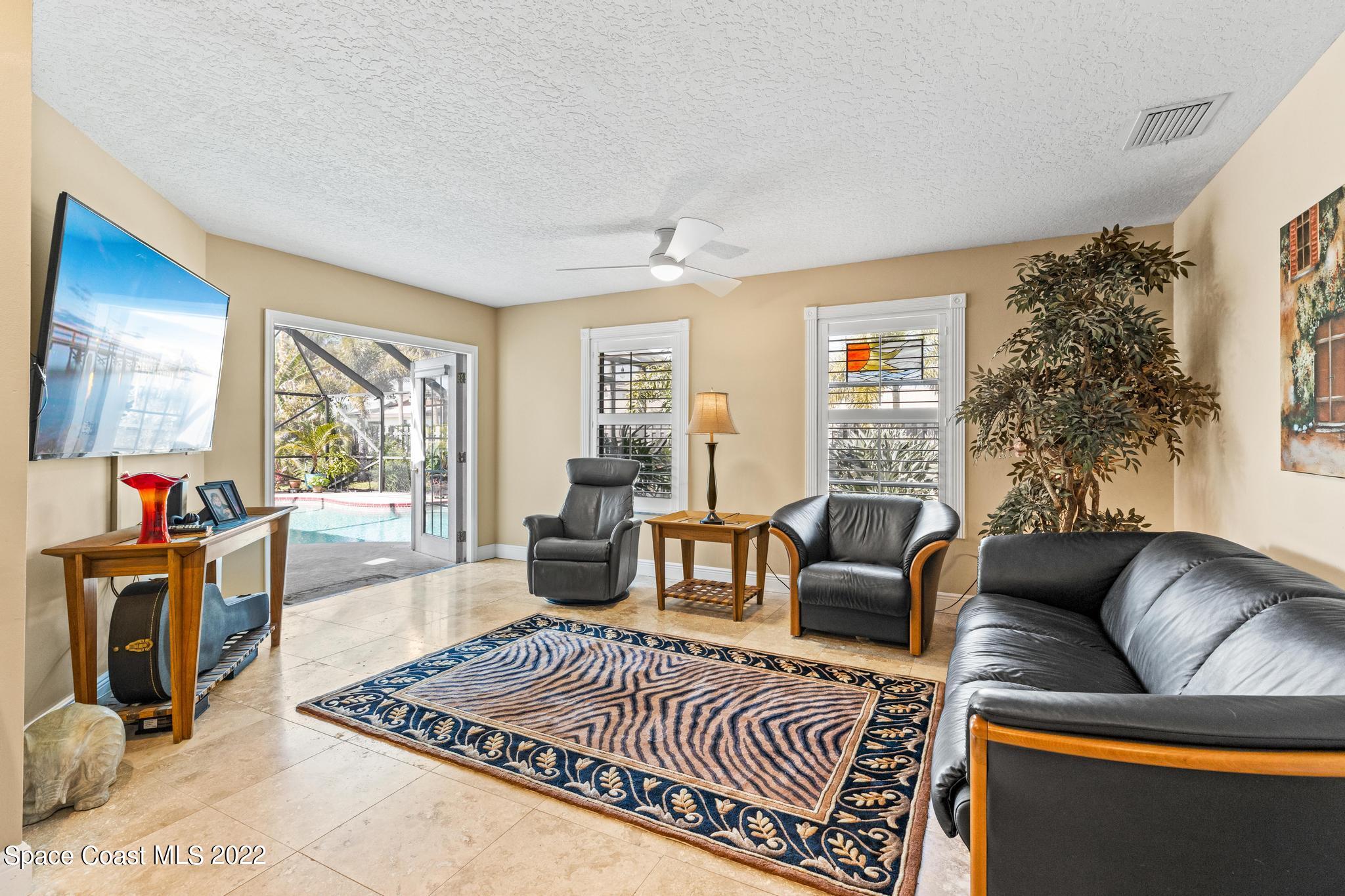 470 Veracruz Boulevard Indialantic, FL 32903 - Photo 7 of 25 a living room with furniture a rug and a large window