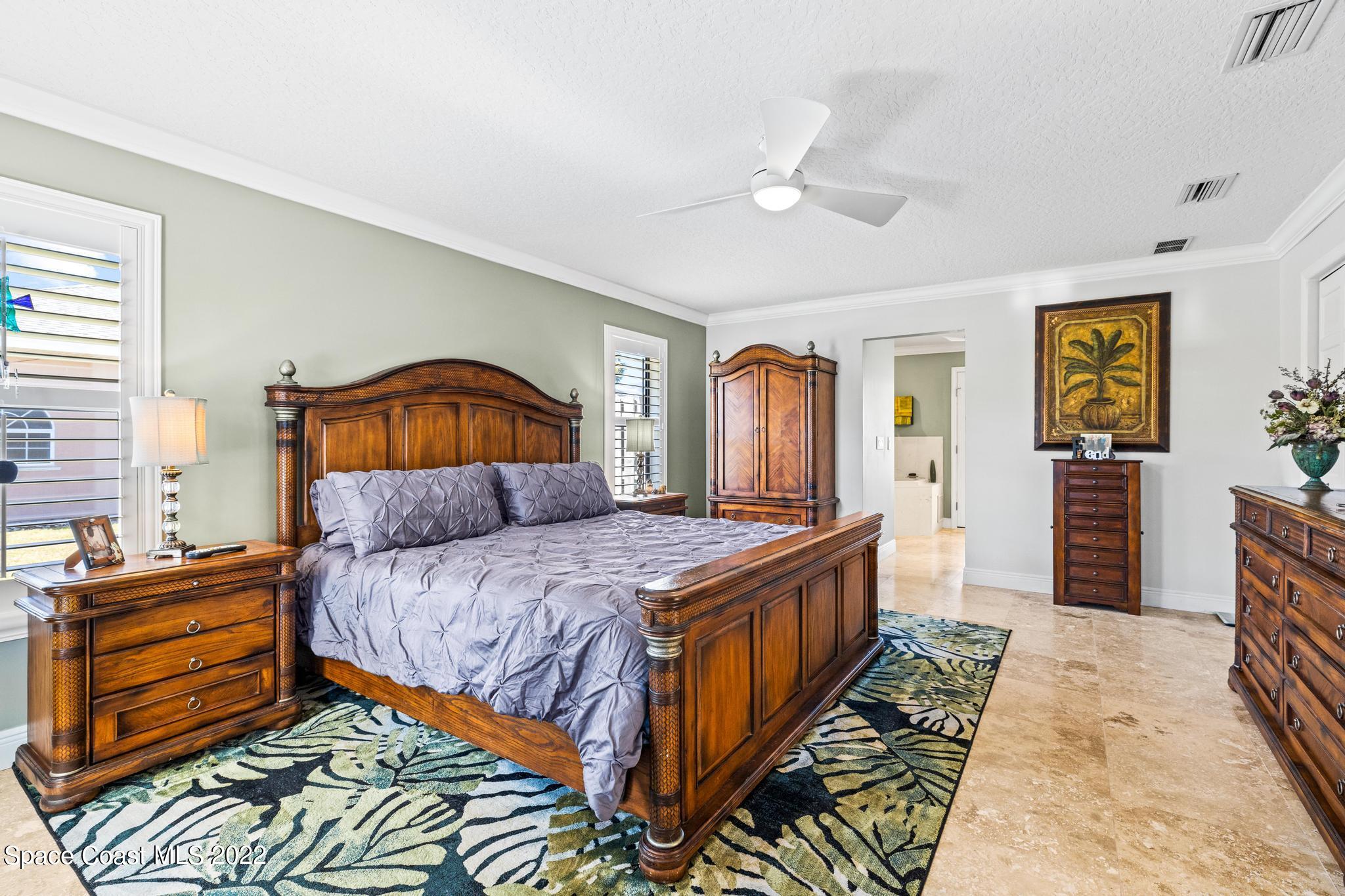 470 Veracruz Boulevard Indialantic, FL 32903 - Photo 8 of 25 a bedroom with a bed and wooden floor