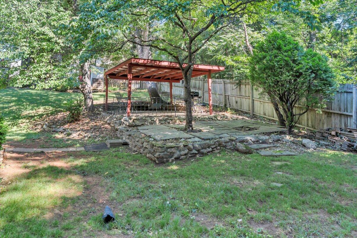 3403 Greencliff Road Roanoke, VA 24018 - Photo 7 of 37 a backyard of a house with table and chairs under an umbrella