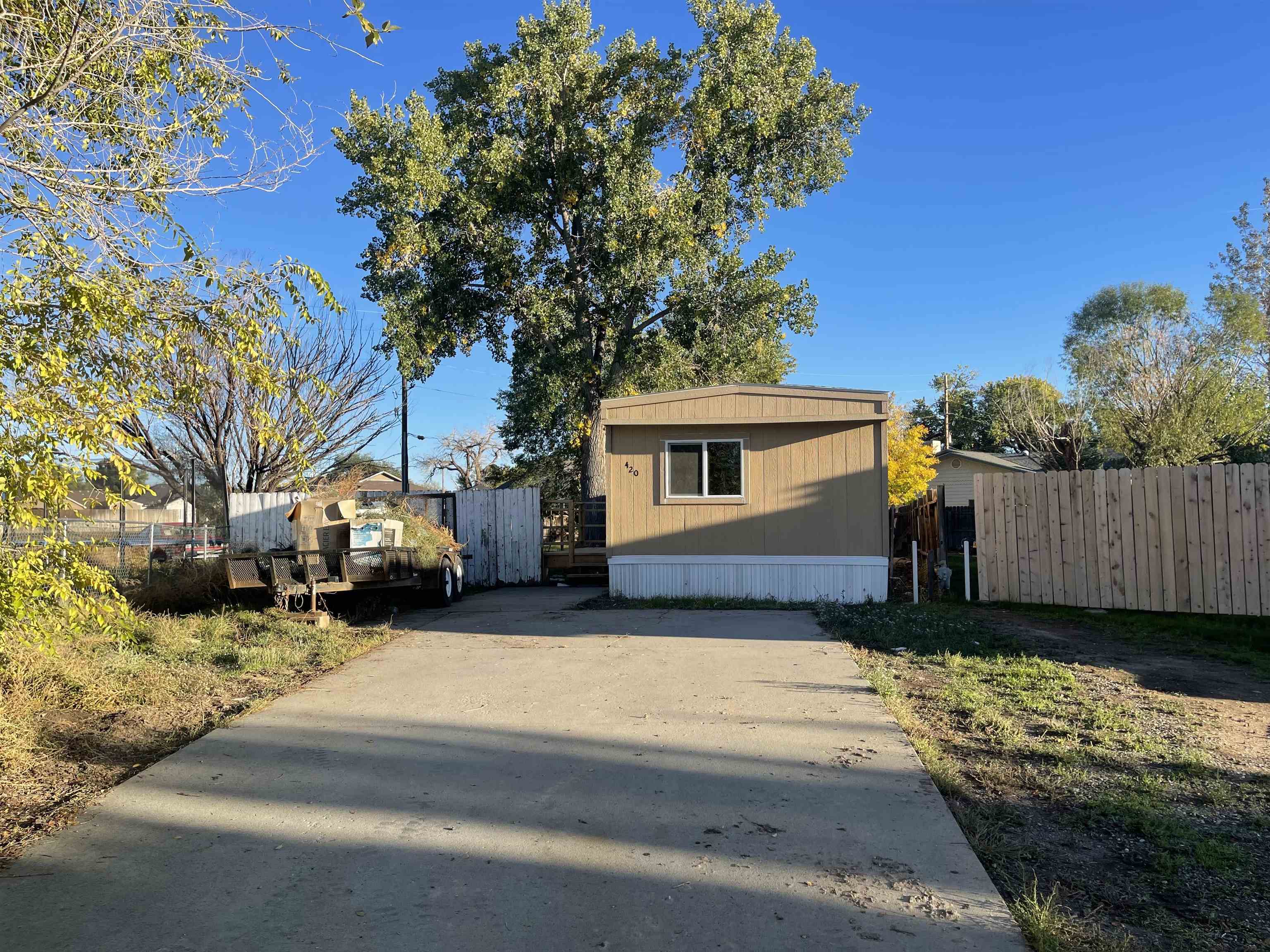 a view of a house with a yard covered in snow